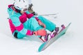 Young beautiful stylish woman strapping on her snowboard Royalty Free Stock Photo