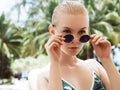 Young beautiful stylish woman summer vacation in thailand, tropical background, resort style, fashion trend happy, sunny