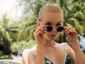 young beautiful stylish woman summer vacation in thailand, tropical background, resort style, fashion trend Royalty Free Stock Photo