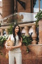 Young beautiful stylish woman wearing green dress and sunglasses walking at the street in city. Pretty brunette girl with long Royalty Free Stock Photo