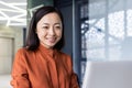 Young beautiful and successful businesswoman closeup at workplace working inside office, asian financier smiling and Royalty Free Stock Photo