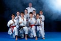 Young, beautiful, successful multi ethical karate kids in karate position. Royalty Free Stock Photo