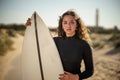 Young beautiful surfer female on the beach at sunset Royalty Free Stock Photo