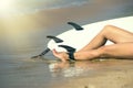 Young beautiful surfer girl on beach with surf board at day break