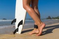 Young beautiful surfer girl on beach with surf board at day break Royalty Free Stock Photo