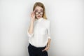 Young beautiful surprised blonde business woman in eyeglasses after business meeting isolated white background Royalty Free Stock Photo