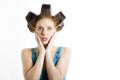 Young beautiful surprized woman with hair curlers