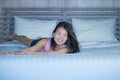 Young beautiful and sweet Asian Chinese woman lying playful and comfortable in bed relaxed and happy at her cozy bedroom smiling c Royalty Free Stock Photo