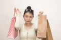 Young beautiful and sweet Asian Japanese woman posing happy and cheerful holding shopping bags excited and cheerful in beauty and