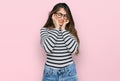 Young beautiful teen girl wearing casual clothes and glasses covering ears with fingers with annoyed expression for the noise of