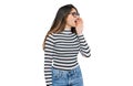 Young beautiful teen girl wearing casual clothes and glasses shouting and screaming loud to side with hand on mouth Royalty Free Stock Photo