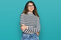 Young beautiful teen girl wearing casual clothes and glasses smiling looking to the side and staring away thinking Royalty Free Stock Photo