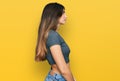 Young beautiful teen girl wearing casual crop top t shirt looking to side, relax profile pose with natural face with confident Royalty Free Stock Photo