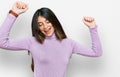 Young beautiful teen girl wearing turtleneck sweater dancing happy and cheerful, smiling moving casual and confident listening to Royalty Free Stock Photo