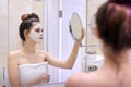 Young beautiful teen girl with white cosmetic natural healing mask on face