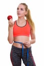 Young beautiful teenage girl holding red apple while thinking an Royalty Free Stock Photo