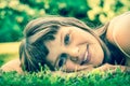 Young beautiful teenage girl lying on the green grass Royalty Free Stock Photo