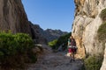 Young, beautiful, teenage woman with backpack hiking in mountains