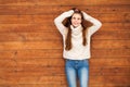 Young beautiful teenager girl posing on a wooden wall background Royalty Free Stock Photo