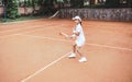 Young and beautiful tennis player in action on the court