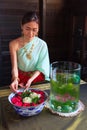 Young Beautiful Thai Asian woman dressing in vintage retro Traditional Thai costume arranging flower bowl. Thailand Cultural and