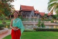 Young Beautiful Thai Asian woman dressing in vintage retro Traditional Thai costume in wait to welcome guest. Thailand Cultural