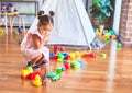 Young beautiful toddler sitting on the floor playing with small cars toys at kindergaten Royalty Free Stock Photo