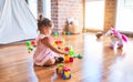 Young beautiful toddler sitting on the floor playing with small cars toys at kindergaten Royalty Free Stock Photo