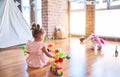 Young beautiful toddler sitting on the floor playing with small cars toys at kindergaten Royalty Free Stock Photo