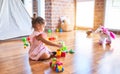 Young beautiful toddler sitting on the floor playing with small cars toys at kindergaten Royalty Free Stock Photo