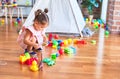 Young beautiful toddler sitting on the floor playing with small cars toys at kindergaten Royalty Free Stock Photo