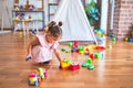 Young beautiful toddler sitting on the floor playing with small cars toys at kindergaten Royalty Free Stock Photo