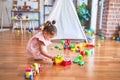 Young beautiful toddler sitting on the floor playing with small cars toys at kindergaten Royalty Free Stock Photo