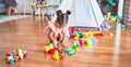 Young beautiful toddler sitting on the floor playing with small cars toys at kindergaten Royalty Free Stock Photo