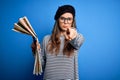 Young beautiful tourist woman on vacation wearing glasses and beret holding city map pointing with finger to the camera and to Royalty Free Stock Photo