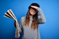 Young beautiful tourist woman on vacation wearing glasses and beret holding city map stressed with hand on head, shocked with Royalty Free Stock Photo