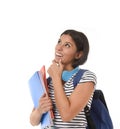 Young beautiful and trendy latin student girl holding notepad folder and book carrying backpack thinking happy Royalty Free Stock Photo