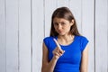 Young beautiful upset girl over white wooden background. Royalty Free Stock Photo