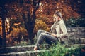 Young beautiful urban woman is reading book while sitting in the Royalty Free Stock Photo