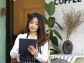 Young beautiful waitress taking an order on digital tablet in restaurant Royalty Free Stock Photo