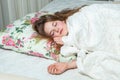 Young beautiful white woman awaking in light room.