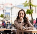 Young beautiful white woman with curly brown hair,against the background of the street Royalty Free Stock Photo