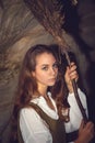 Young beautiful witch in her cave. Royalty Free Stock Photo