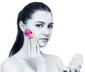 Young beautiful woman applying flowers cosmetic on face. Royalty Free Stock Photo