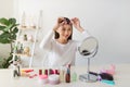 Young beautiful woman applying her make-up Royalty Free Stock Photo