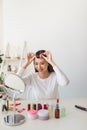 Young beautiful woman applying her make-up Royalty Free Stock Photo