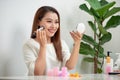 Young beautiful woman applying her make-up with a big brush , lo Royalty Free Stock Photo