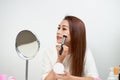 Young beautiful woman applying her make-up with a big brush , lo Royalty Free Stock Photo