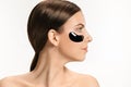 Young beautiful woman applying a mask for the face of the therapeutic black mud. Spa treatment Royalty Free Stock Photo