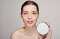 Young beautiful woman applying moisturizing cream on her face Royalty Free Stock Photo